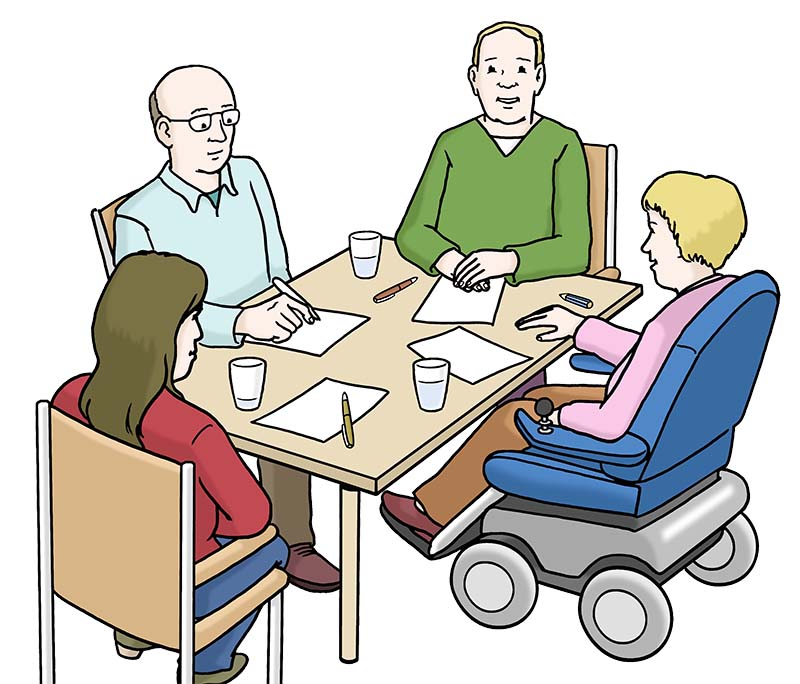 Vier Menschen sitzen am Tisch